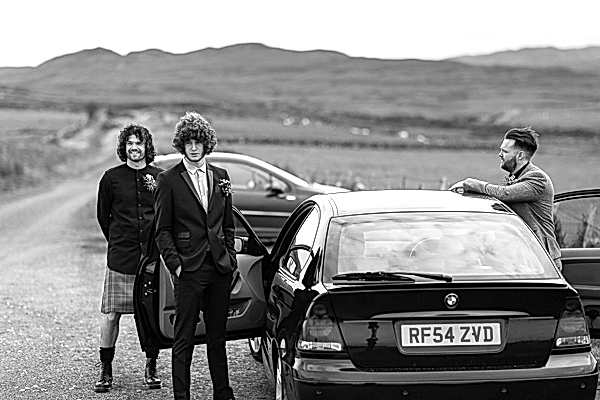 groom with best mannext to car