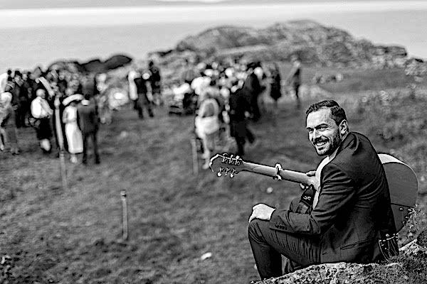 guitar player smiling playing at ceremony