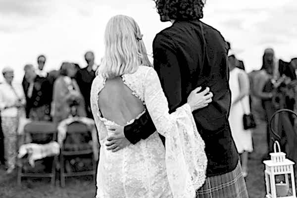 newlyweds embraced during ceremony