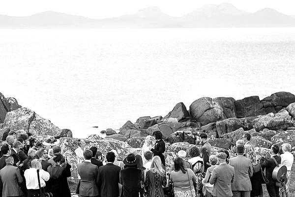 bride and groom about to kiss while guests watching
