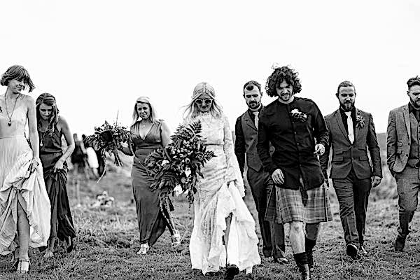 bride and groom with bridal party walking from wedding ceremony