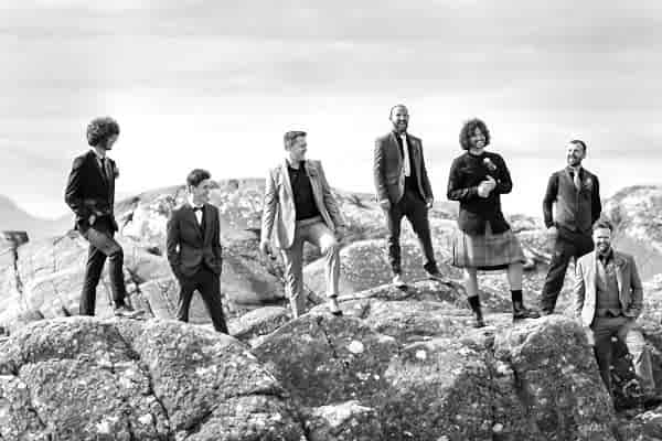 groom with groomsmen on a rock