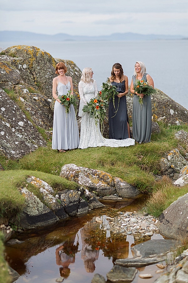 bridesmates standing on a rocky beach in scotland