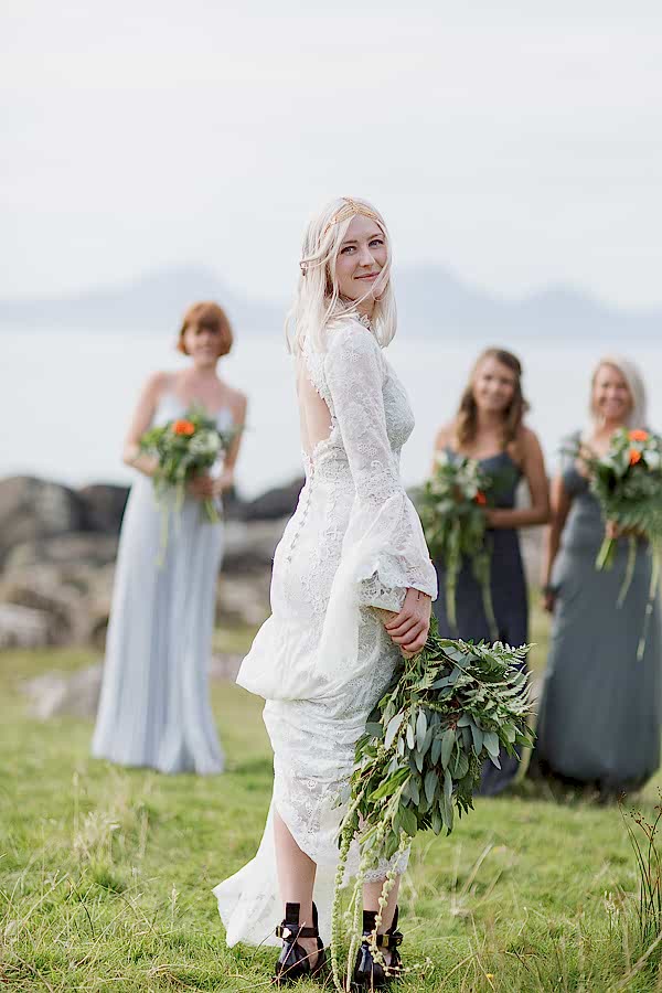 bride looking at the camera with bridesmates in the background