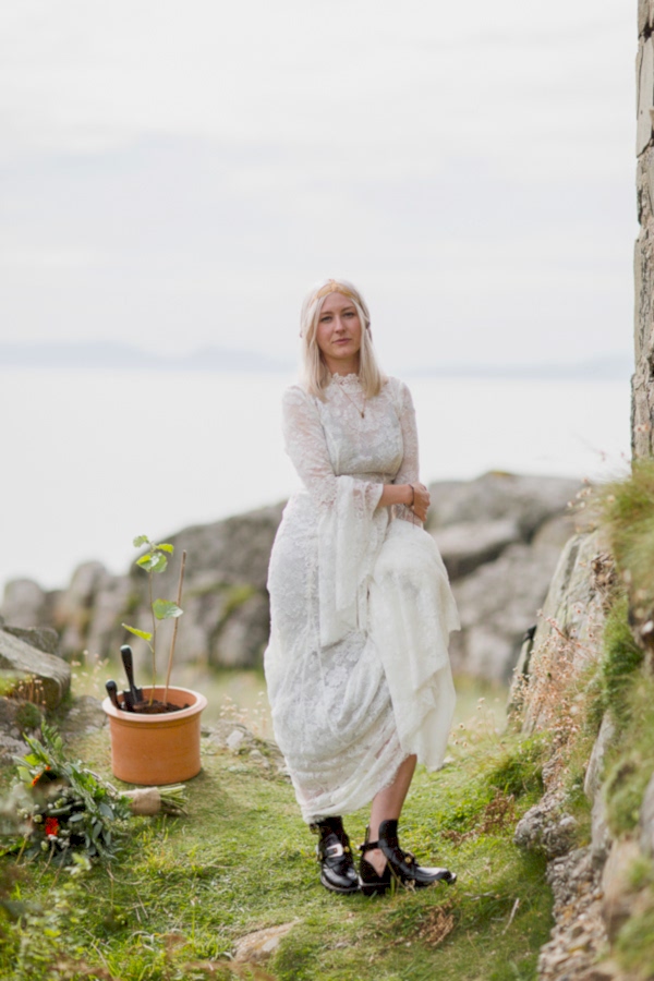 blond bride standing holding her dress