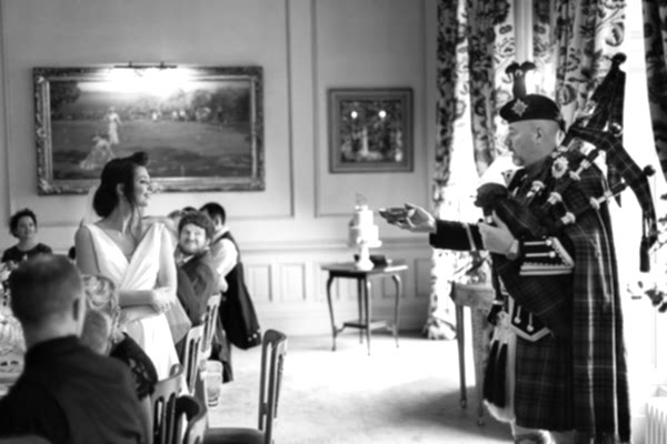 tradiotiona scottish piper whisky toast during wedding at dundas castle