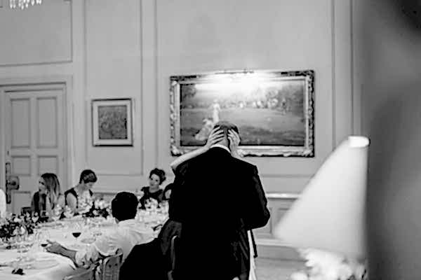 bride embracing groom during his wedding speech