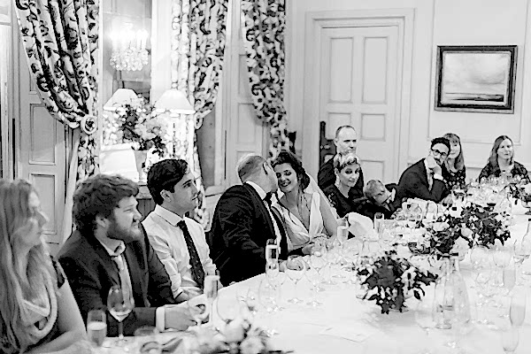 bride and groom kissing by the table