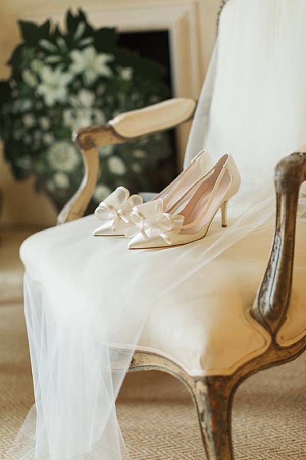 wedding shoes and veil on armchair