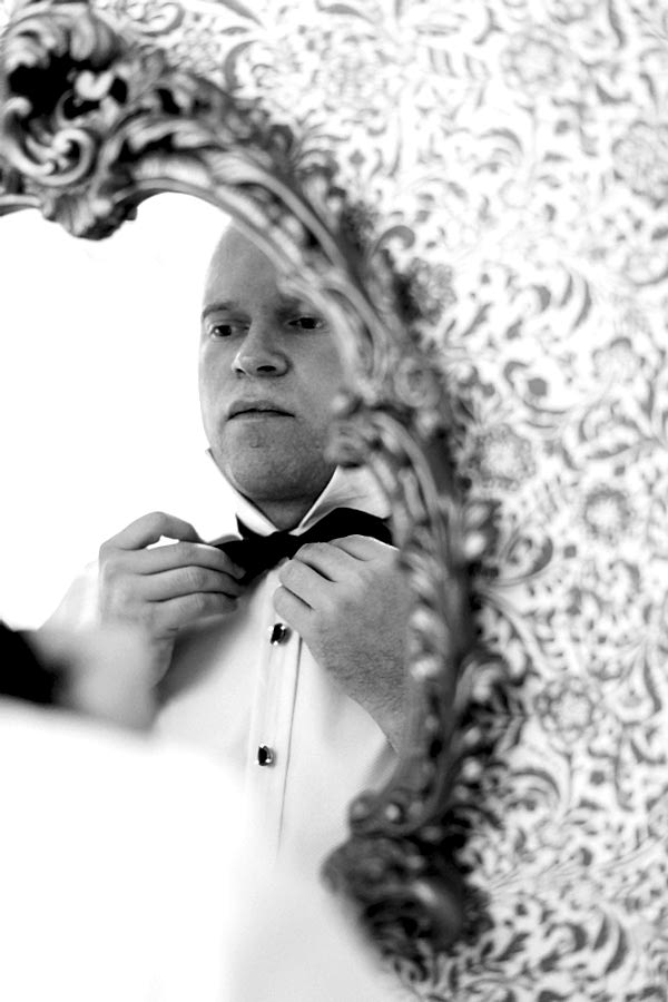 groom putting his bowtie