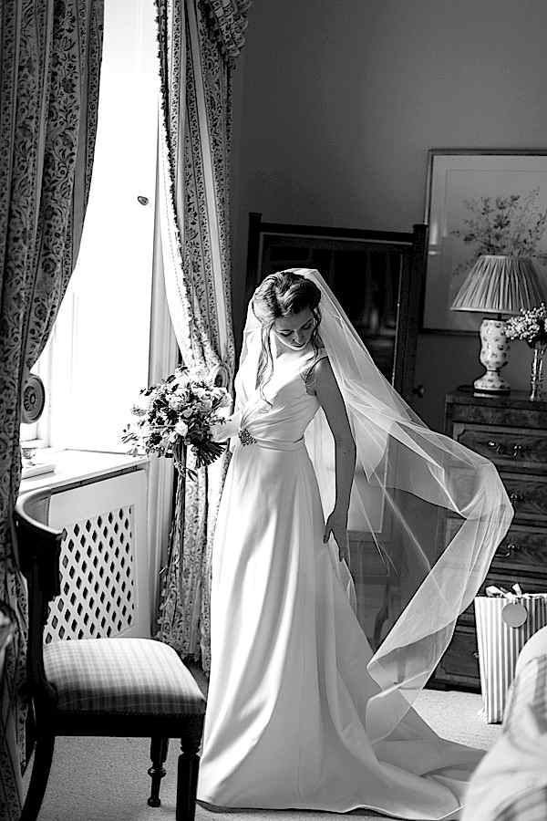 bride fixing her dress just before leaving for ceremony