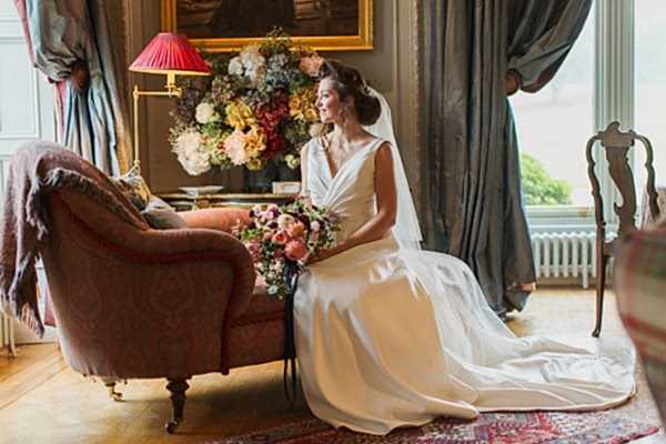 bride sitting in the main hall of dundas castle