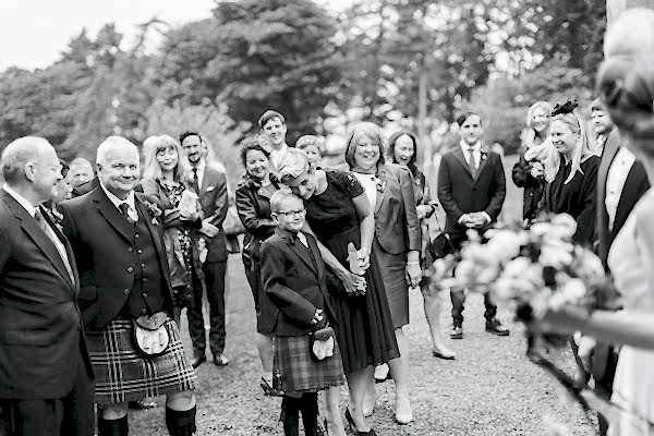 guests looking at newlyweds outside the church