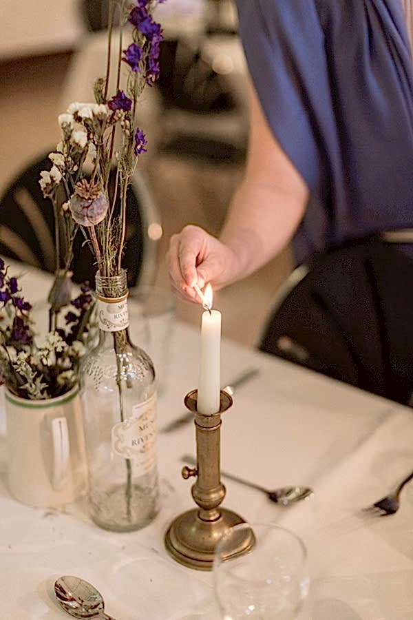 candels beeing lit at wedding reception