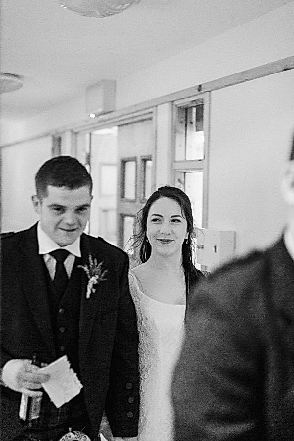 bride and groom beeing piped into the room