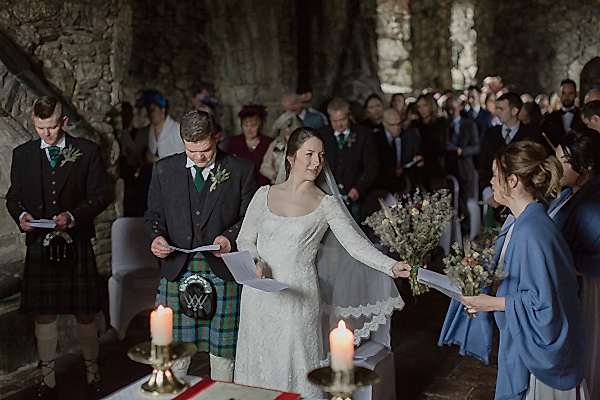 bride handing over the flowers to one of the bridesmates