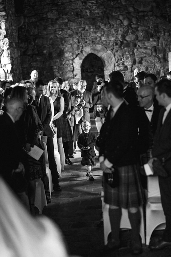 page boy walking down with wedding rings