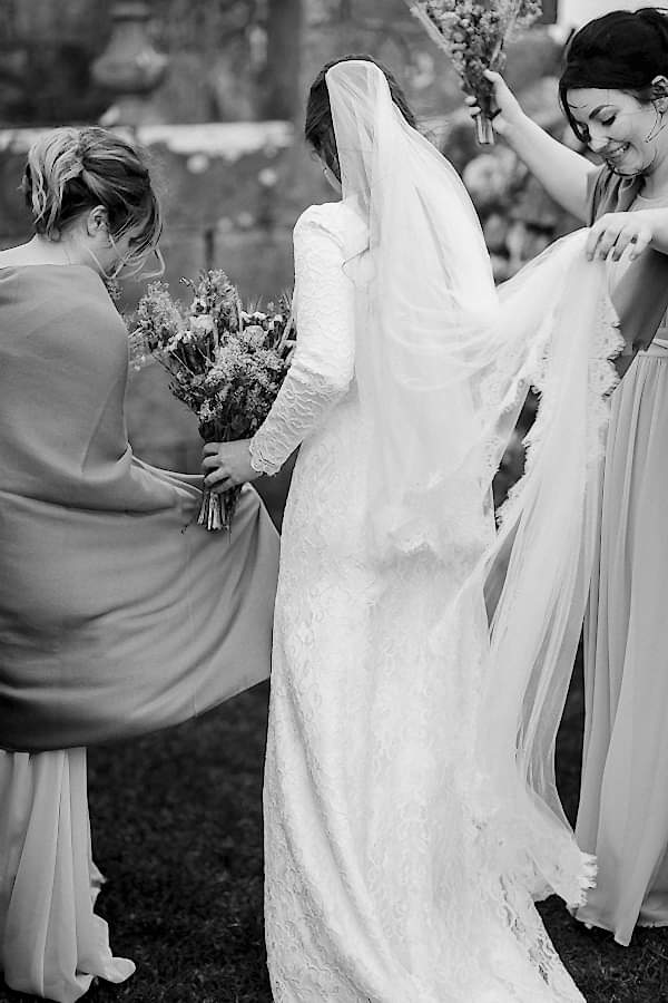 bride and bridemsates fixing dresses