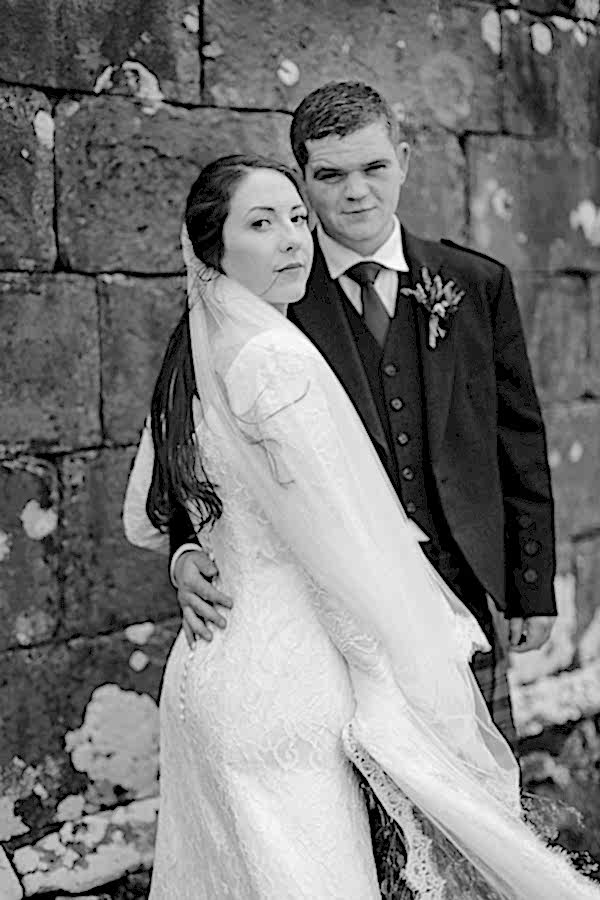 newlyweds looking at the camera