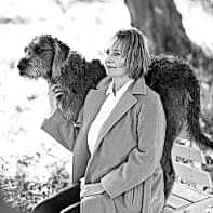 portrait woman with dog sitting in coat joga teacher