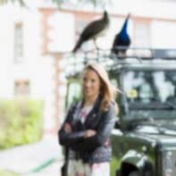portrait of engaged girl with landrover and peacocks