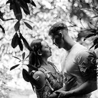 young couple embraced betwen leaves in summer engagement photos