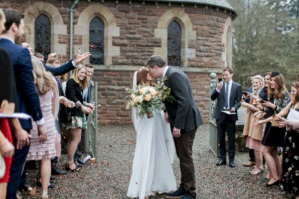 a couple kiss outside of the chapel cromlix 