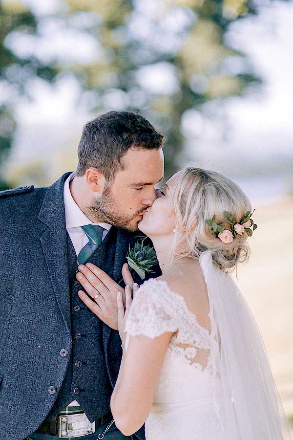 a married couple kissing in the garden loch lomond 