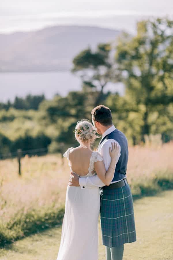 wedding couple looking at the view of loch lomond 