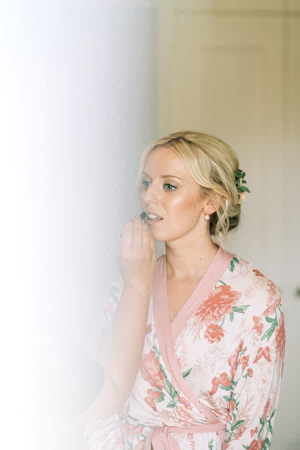 bride is getting her make up done