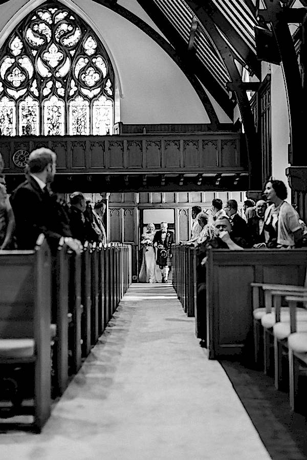 bride and her father walking on the aisle 