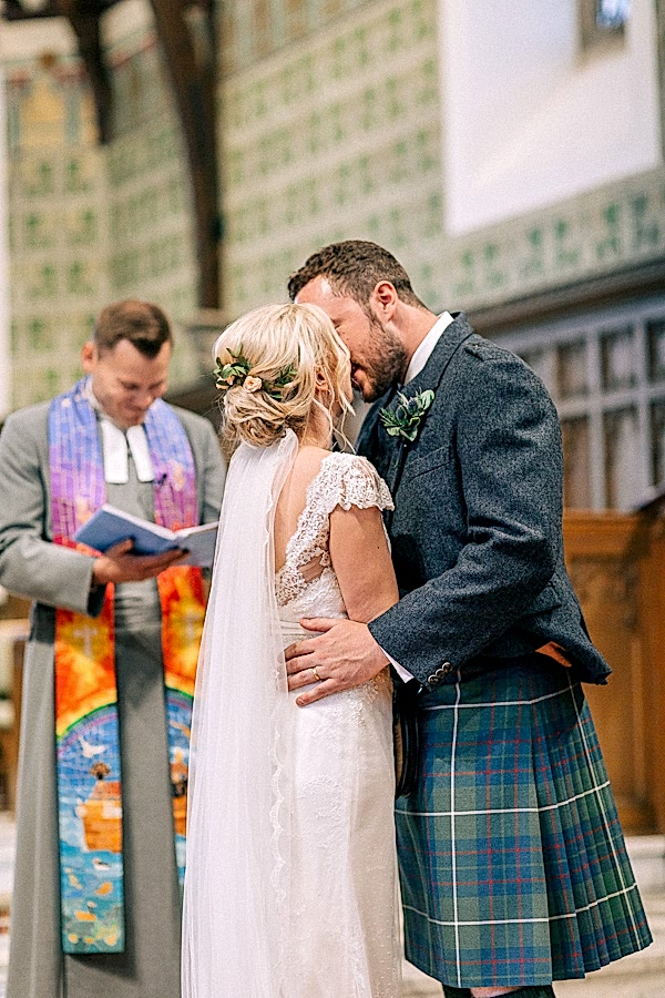 couple at the altar kissing 