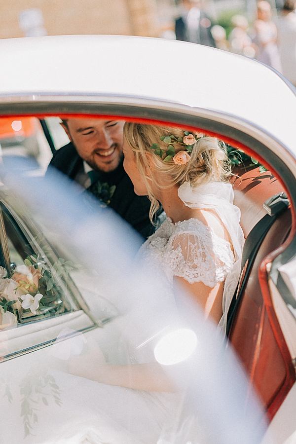 freshly married couple in the car 