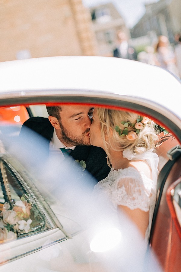 married couple kissing in the car 
