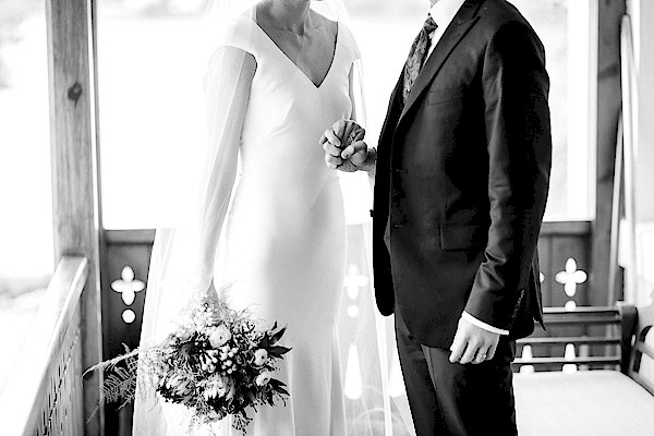 newlyweds holding hands on the veranda at loch goil