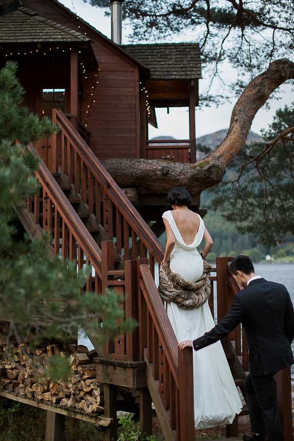 bride and groom walking up the stairs