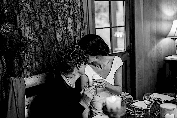bride and mother wispering to each other 