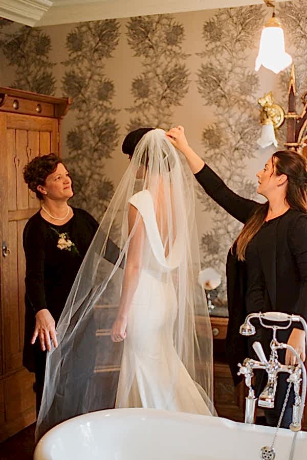 laura grey fixing brides veil at loch goil