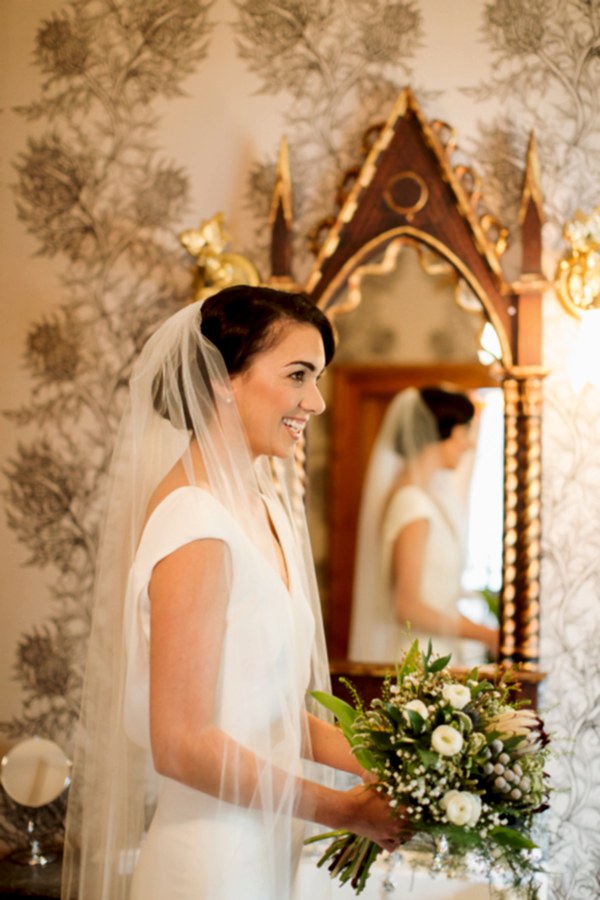 bride laughing holding her flowers