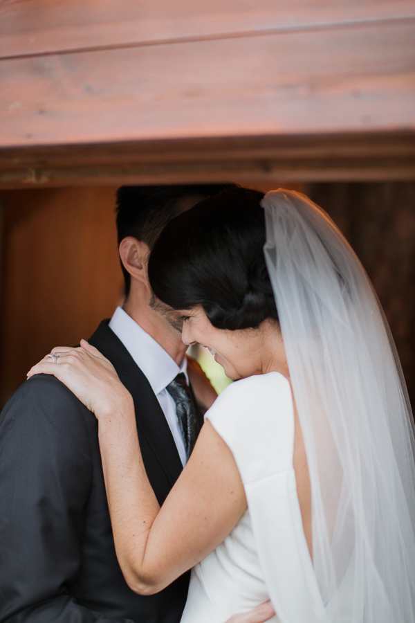 bride and groom laughing after first kiss