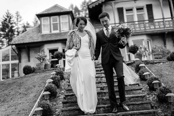 bride and groom walking down stairs to the garden