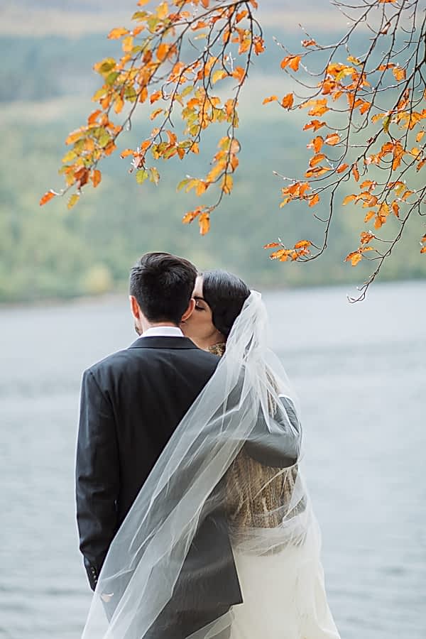 bride kissing groom wedding photo the lodge on loch goil scotland