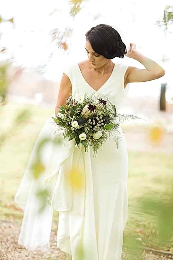 bride fising her veil during wedding sesion with photographer