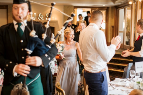 bridal party beeing piped in to the room