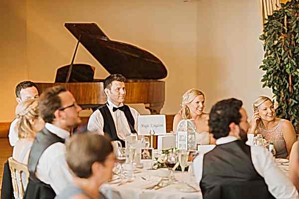 bride and groom listening to the speeches