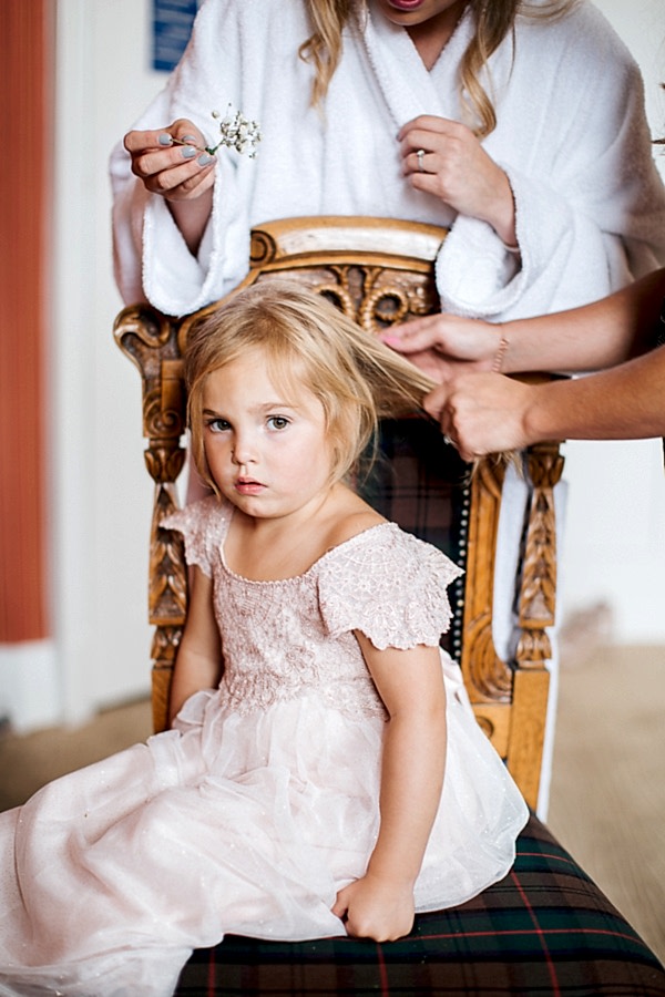 flower girl having her hair done during preparations