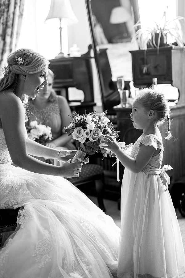 flower girl touching the bride