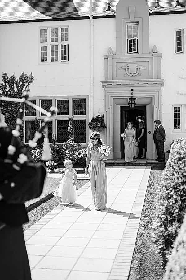 bridesmates beeing piped outside for ceremony