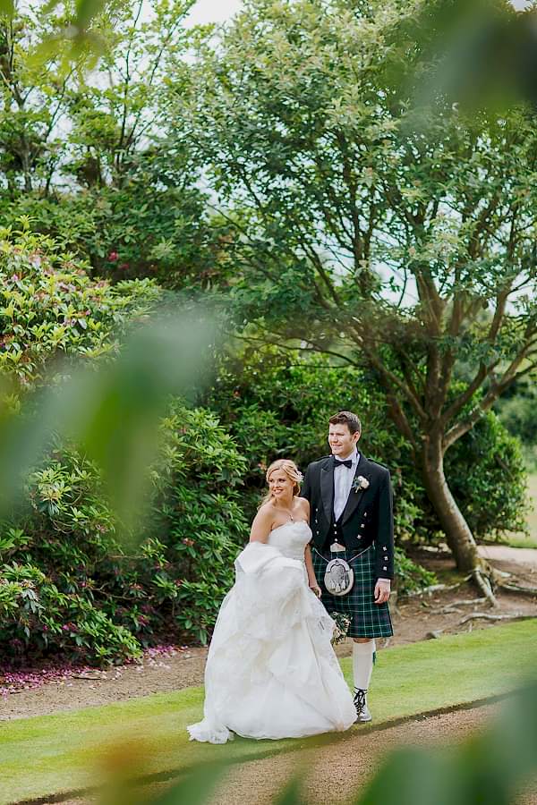 bride and groom together in the garden 