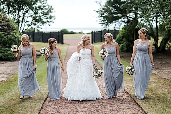 bride and bridesmates walking in the garden